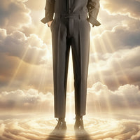 Person wearing dark gray pants and black shoes against a textured wall.